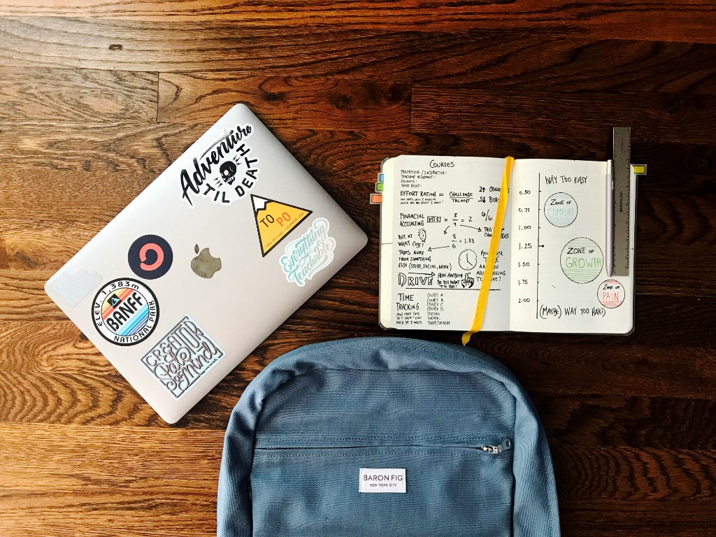 Laptop, notebook, and study materials on a desk